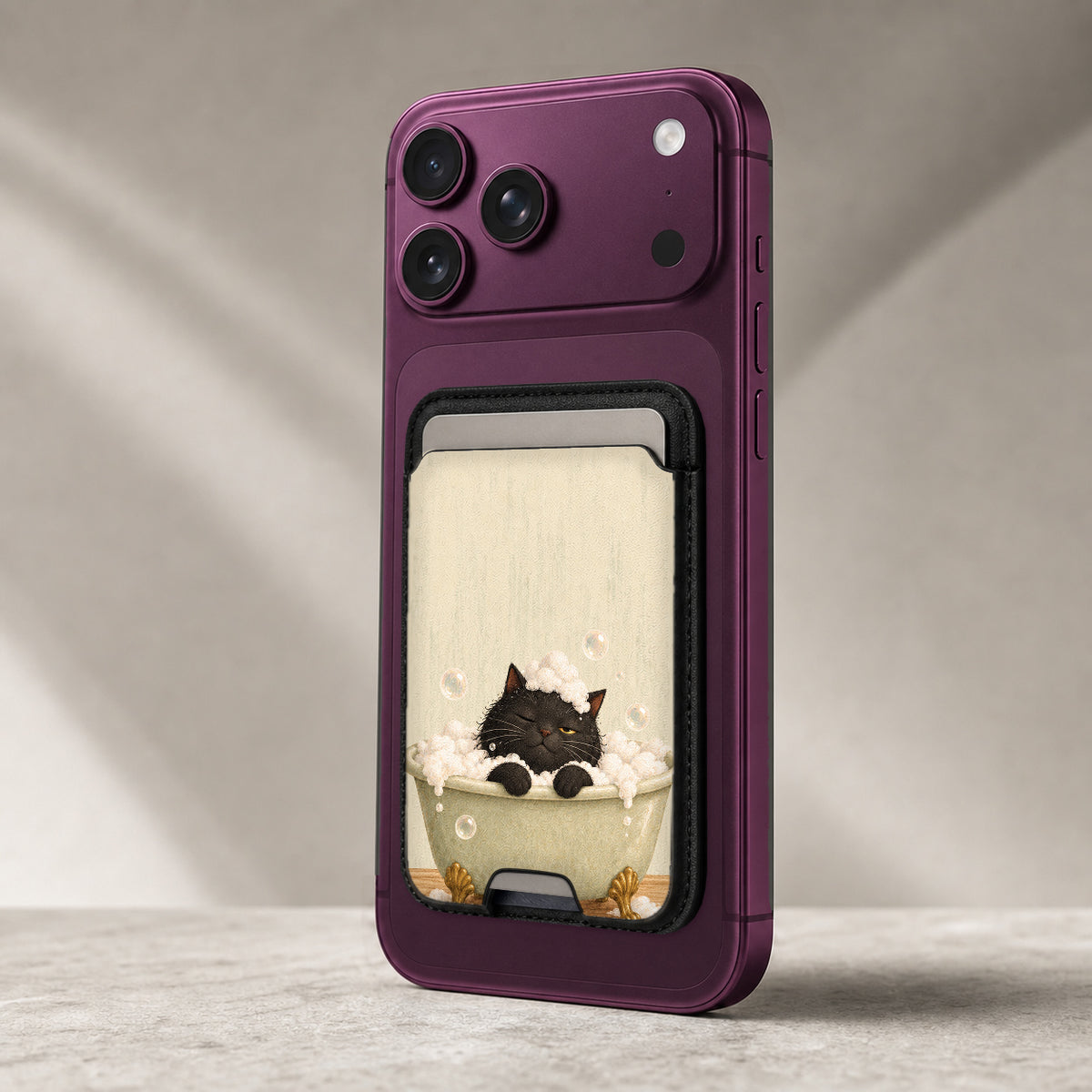 Bubble Bath Black Cat MagSafe Card Holder, attached to a compatible phone