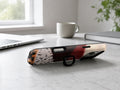 Burgundy Cream Abstract Animal Print MagSafe Loop iPhone Case shown in a neutral white professional lifestyle setting