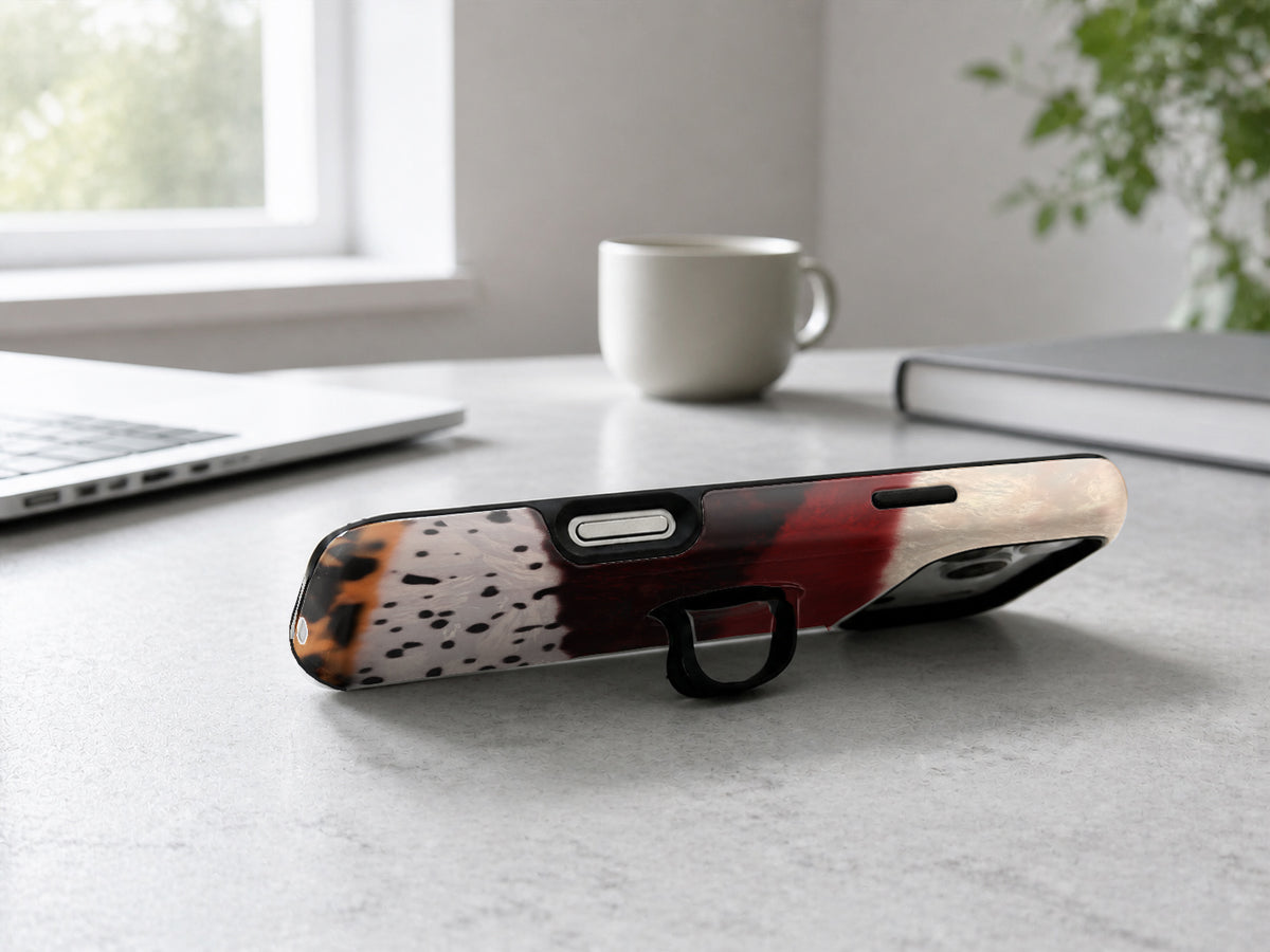 Burgundy Cream Abstract Animal Print MagSafe Loop iPhone Case shown in a neutral white professional lifestyle setting