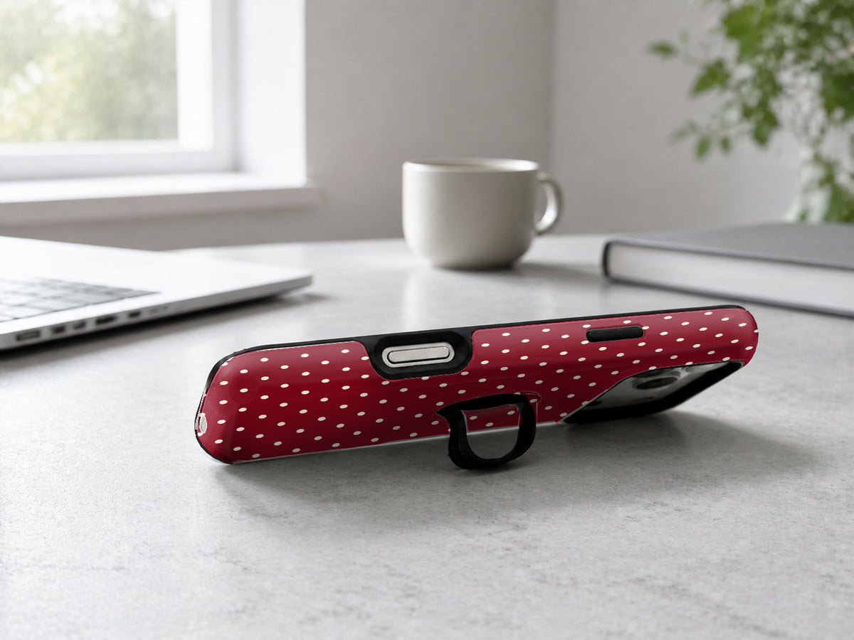 Burgundy Mini Polka Dot MagSafe Loop iPhone Case shown in a neutral white professional lifestyle setting