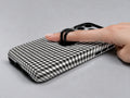 Charcoal Black and White Gingham MagSafe Loop Case, shown with a finger through the loop