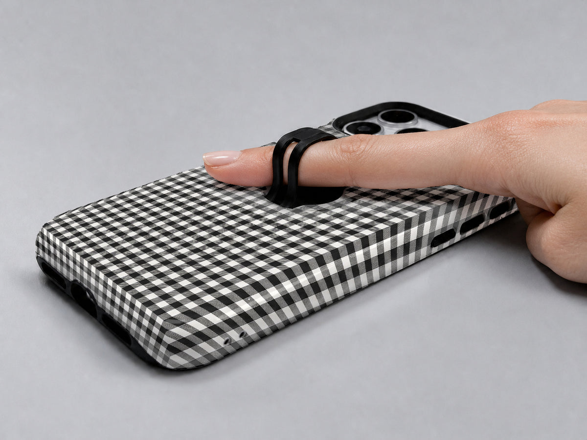 Charcoal Black and White Gingham MagSafe Loop Case, shown with a finger through the loop