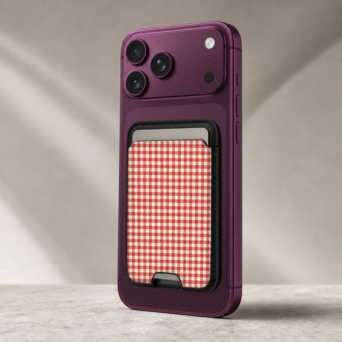 Cherry Red and White Gingham MagSafe Card Holder, attached to a compatible phone