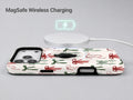 Christmas Bow and Mistletoe MagSafe Loop iPhone Case shown with a MagSafe-compatible wireless charger attached