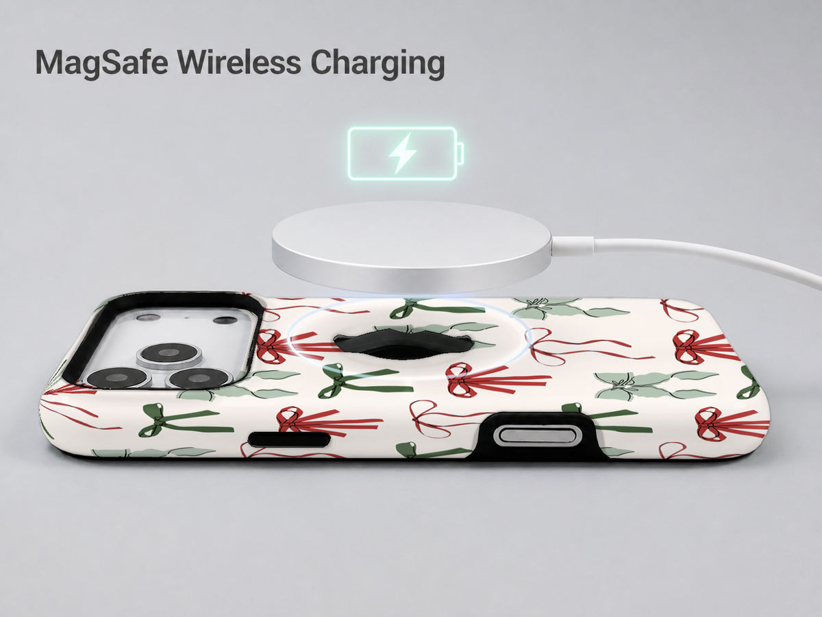 Christmas Bow and Mistletoe MagSafe Loop iPhone Case shown with a MagSafe-compatible wireless charger attached