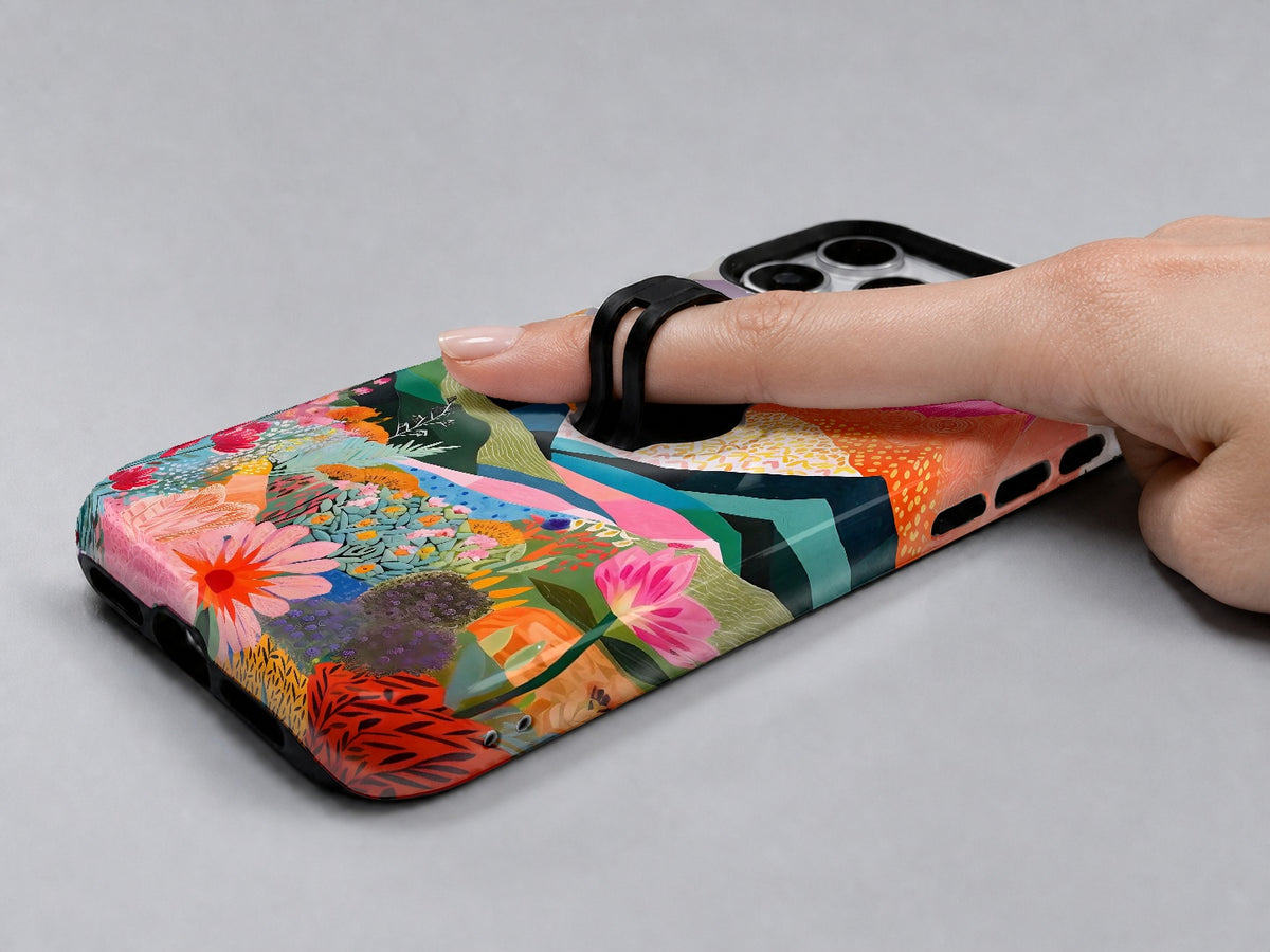 Colorful Abstract Landscape Floral MagSafe Loop iPhone Case shown in use with a finger through the horizontal loop