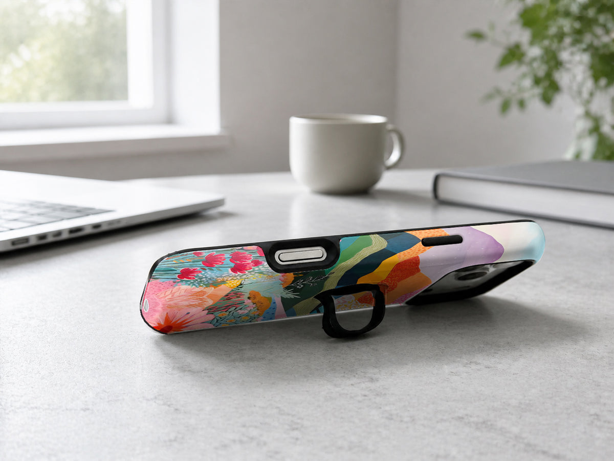 Colorful Abstract Landscape Floral MagSafe Loop iPhone Case shown in a neutral white professional lifestyle setting