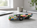 Colorful Folk Quilt Patchwork MagSafe Loop iPhone Case shown in a neutral white professional lifestyle setting