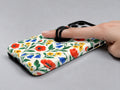 Colorful Wildflower Garden MagSafe Loop Case, shown with a finger through the loop