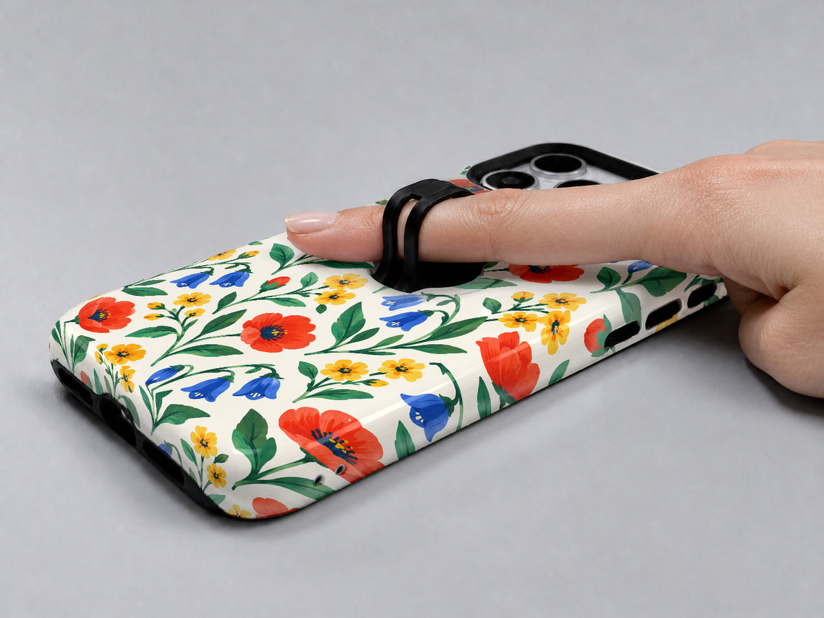 Colorful Wildflower Garden MagSafe Loop Case, shown with a finger through the loop
