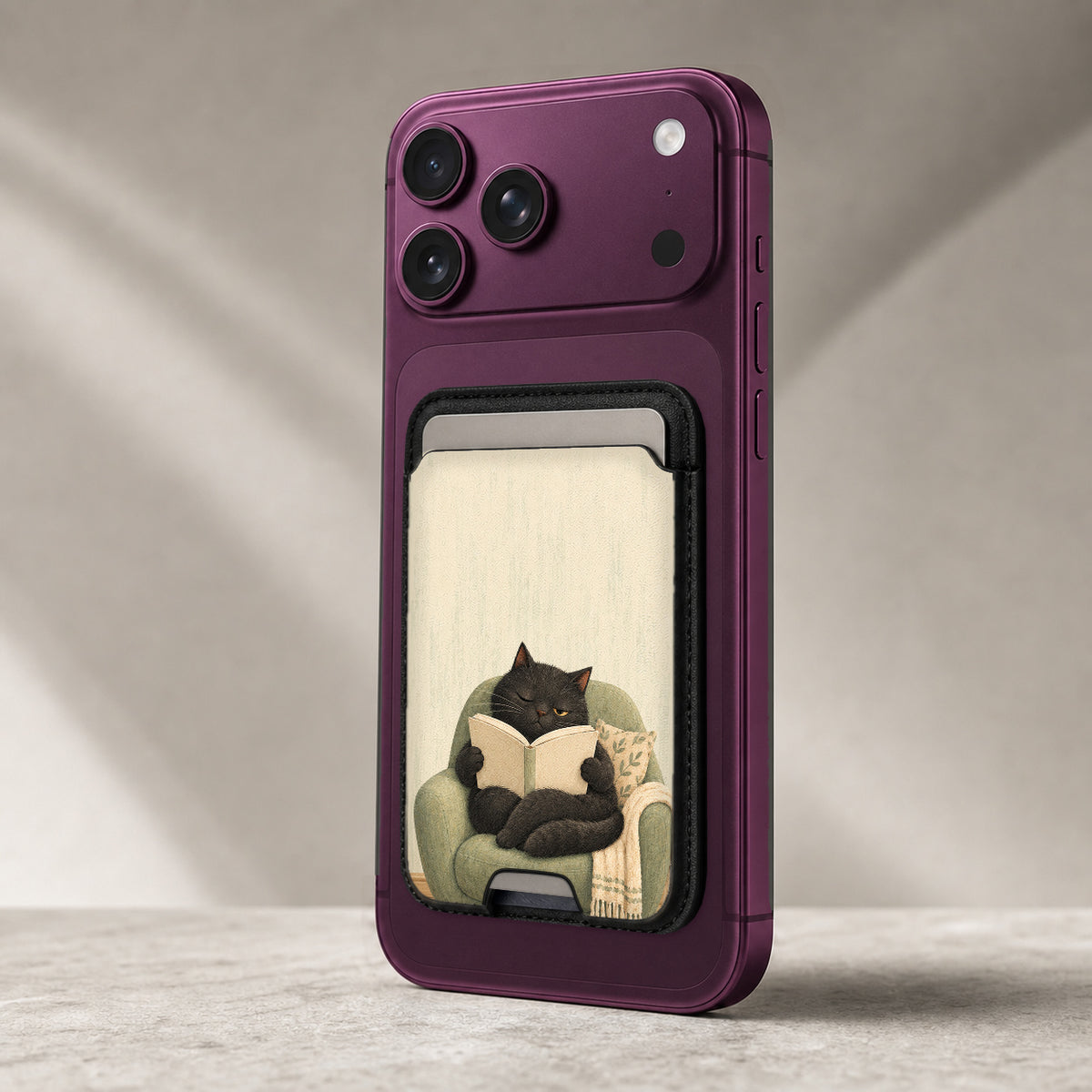Cozy Reading Black Cat MagSafe Card Holder, attached to a compatible phone