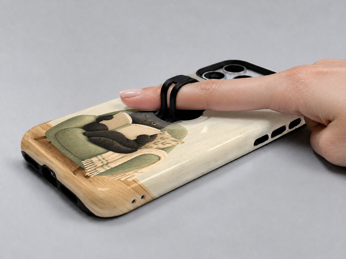 Cozy Reading Black Cat MagSafe Loop Case, shown with a finger through the loop