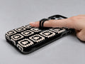 Cream Ghost Granny Square Pattern MagSafe Loop Case, shown with a finger through the loop