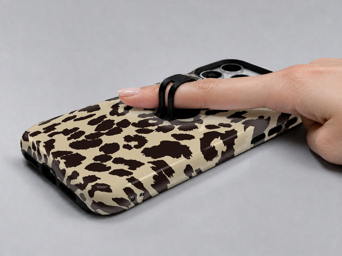 Cream Leopard Print MagSafe Loop iPhone Case shown in use with a finger through the horizontal loop