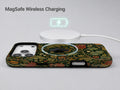 Dark Arts and Crafts Floral MagSafe Loop iPhone Case shown with a MagSafe-compatible wireless charger attached