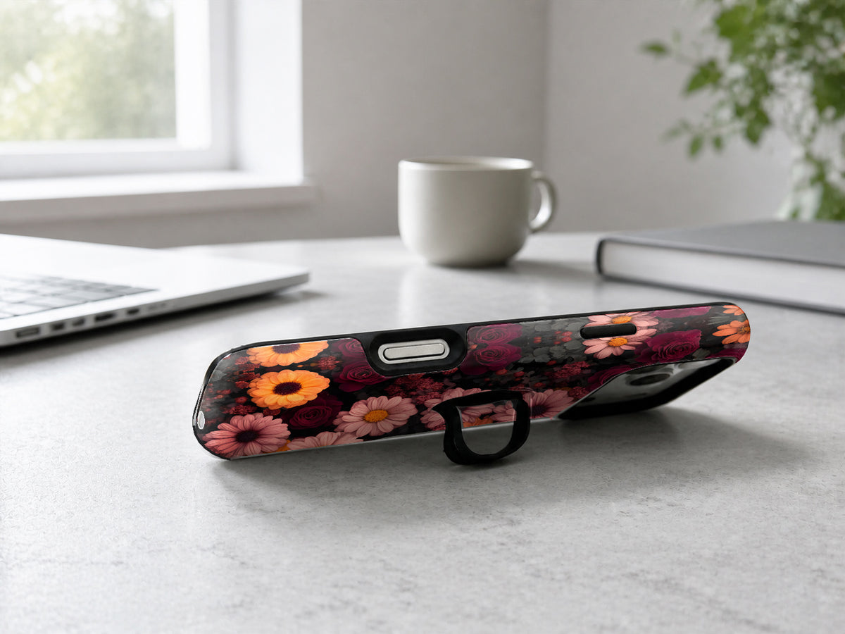 Dark Autumn Daisy Floral MagSafe Loop iPhone Case shown in a neutral white professional lifestyle setting