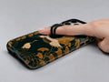 Dark Green Crane MagSafe Loop iPhone Case shown in use with a finger through the horizontal loop