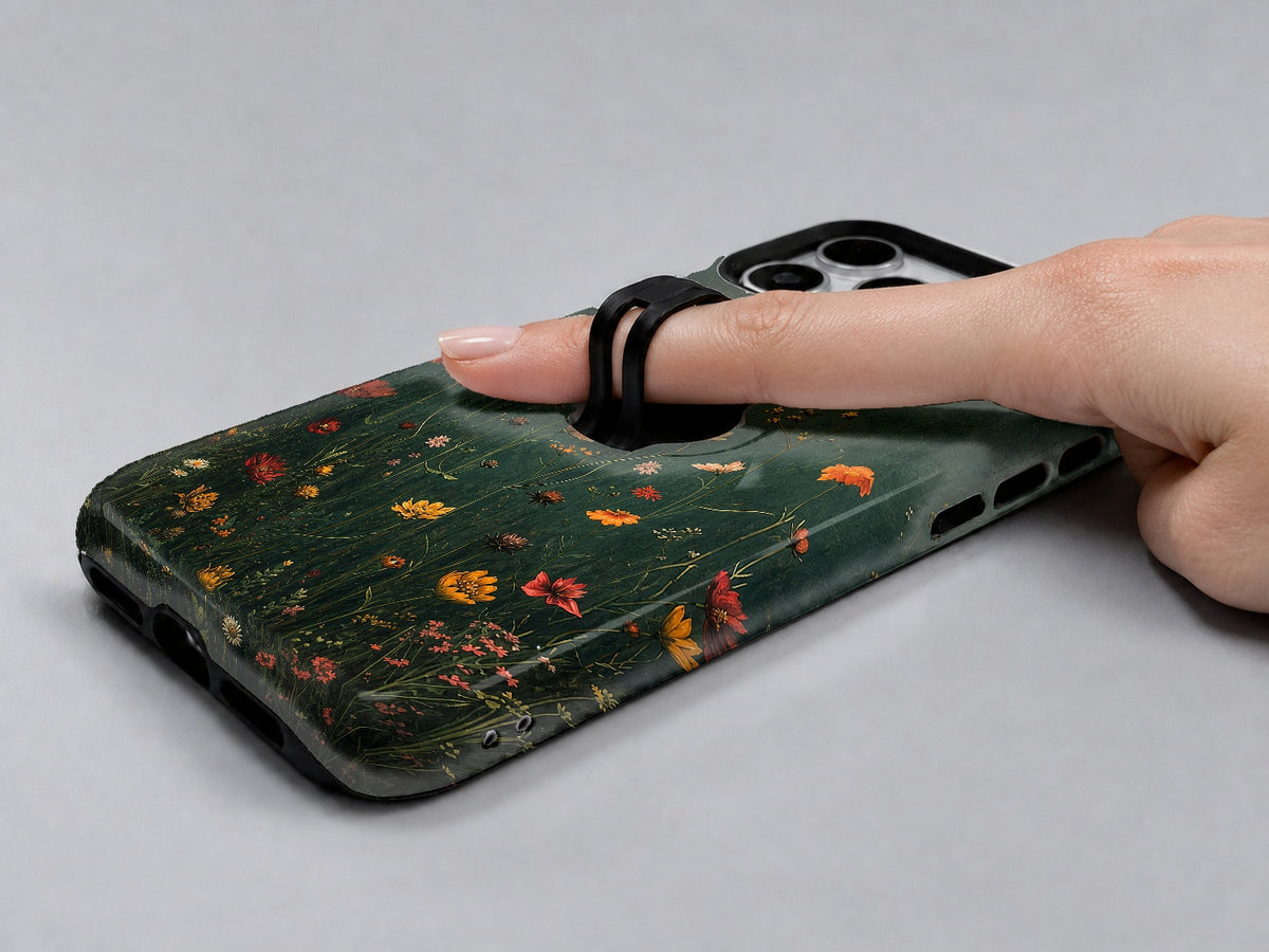 Dark Green Golden Wildflower Meadow MagSafe Loop iPhone Case shown in use with a finger through the horizontal loop
