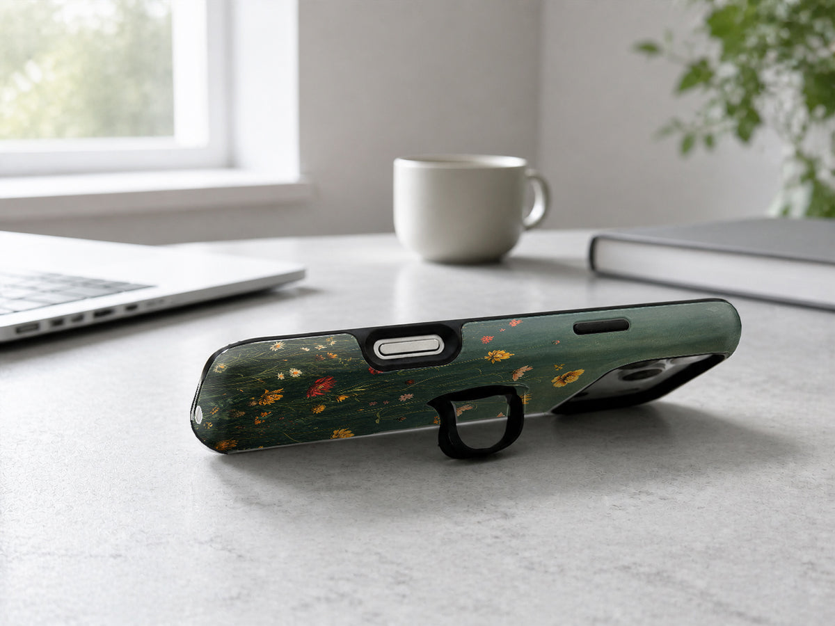 Dark Green Golden Wildflower Meadow MagSafe Loop iPhone Case shown in a neutral white professional lifestyle setting