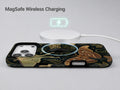 Dark Moth Botanical MagSafe Loop iPhone Case shown with a MagSafe-compatible wireless charger attached
