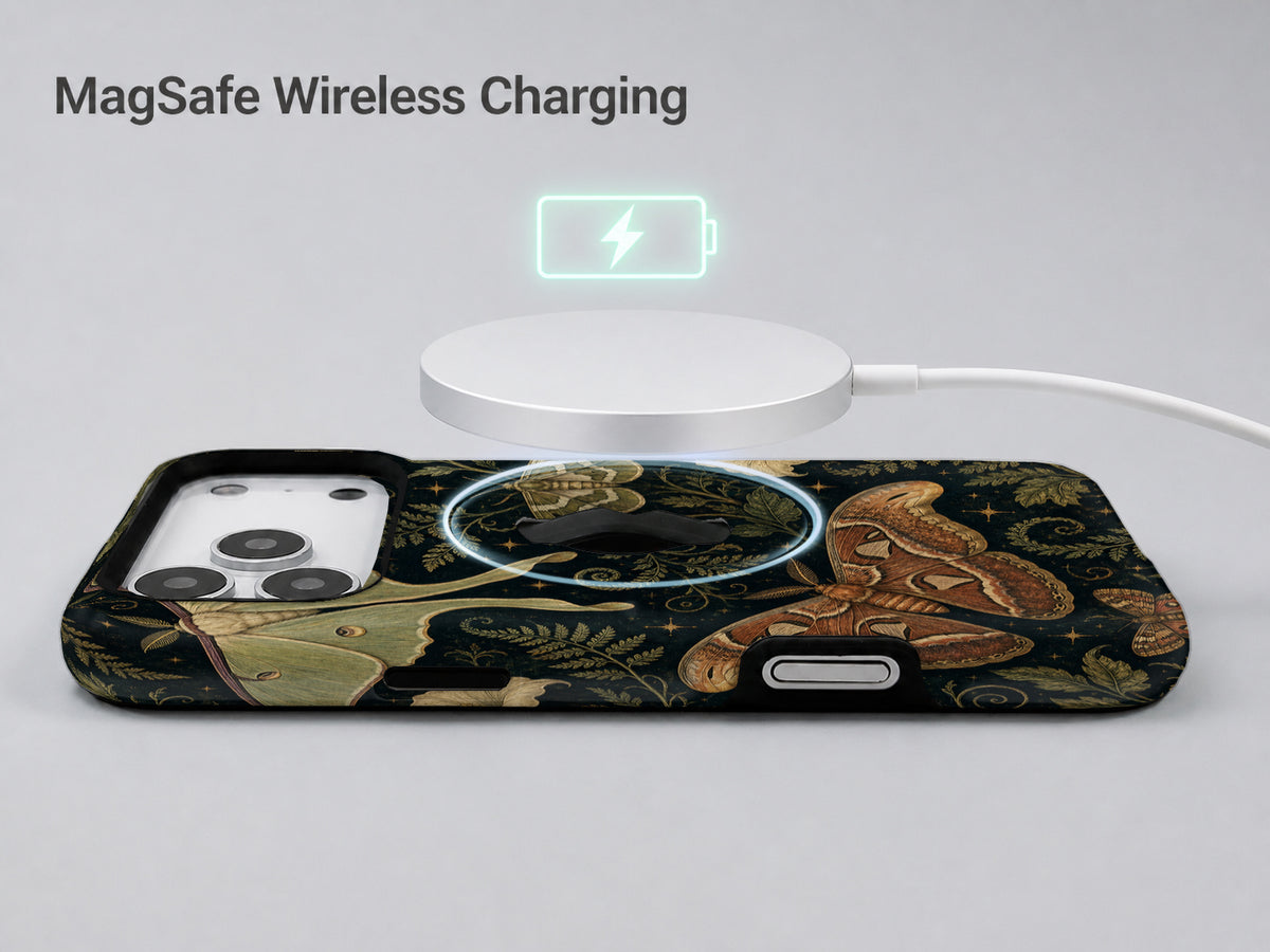 Dark Moth Botanical MagSafe Loop iPhone Case shown with a MagSafe-compatible wireless charger attached