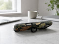 Dark Moth Botanical MagSafe Loop iPhone Case shown in a neutral white professional lifestyle setting