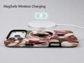 Dusty Rose Magnolia Floral MagSafe Loop iPhone Case shown with a MagSafe-compatible wireless charger attached