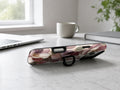 Dusty Rose Magnolia Floral MagSafe Loop iPhone Case shown in a neutral white professional lifestyle setting