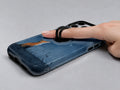 Fox Under Starry Sky MagSafe Loop iPhone Case shown in use with a finger through the horizontal loop