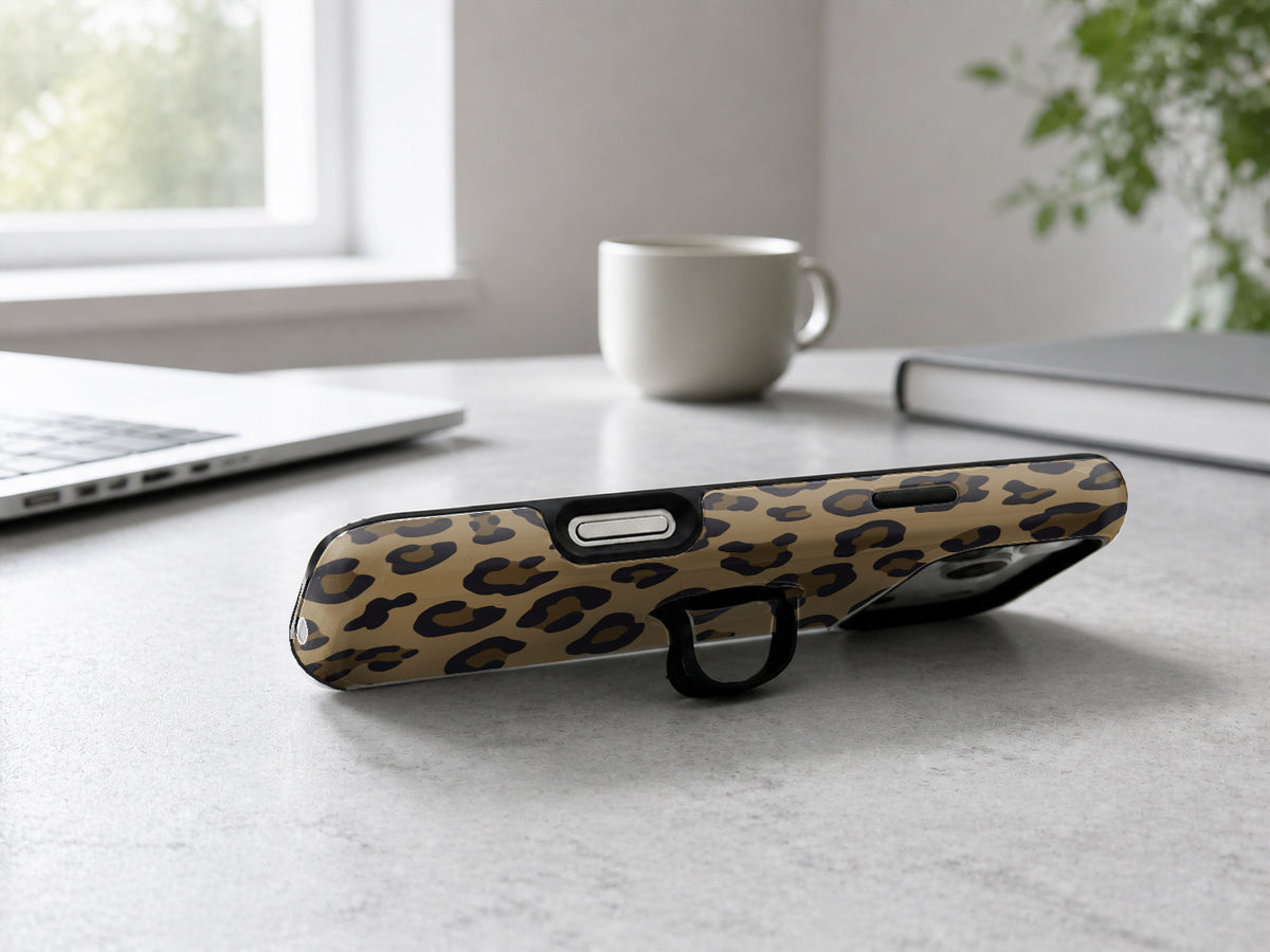 Golden Leopard Print MagSafe Loop iPhone Case shown in a neutral white professional lifestyle setting