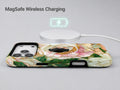 Green Peach Stained Glass Floral MagSafe Loop iPhone Case shown with a MagSafe-compatible wireless charger attached