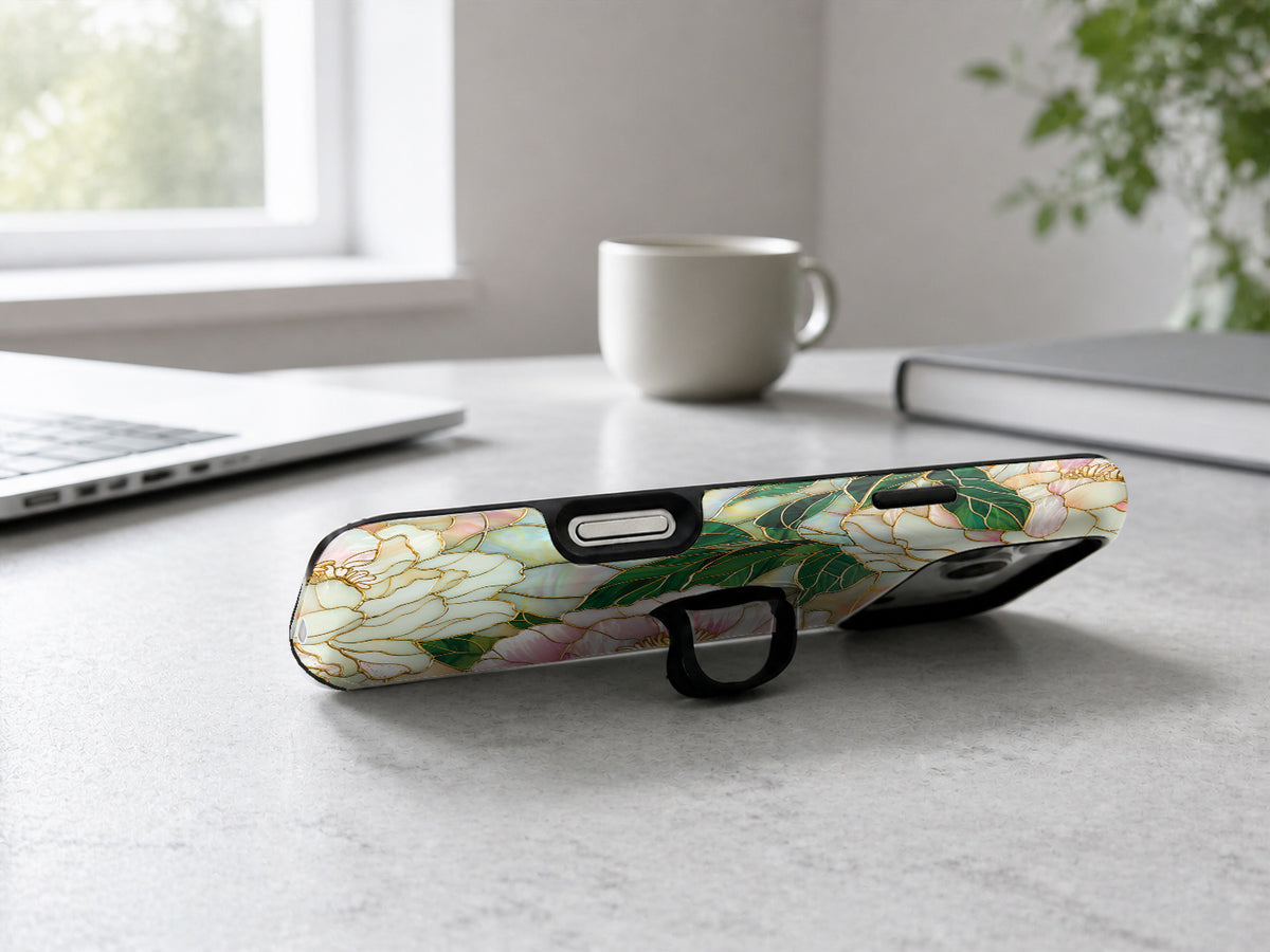 Green Peach Stained Glass Floral MagSafe Loop iPhone Case shown in a neutral white professional lifestyle setting