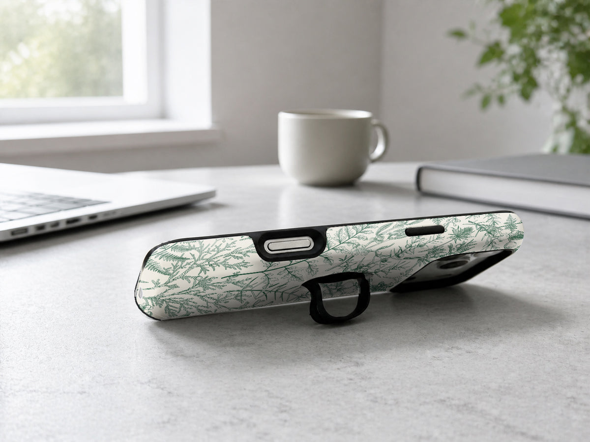 Green Toile Botanical MagSafe Loop iPhone Case shown in a neutral white professional lifestyle setting