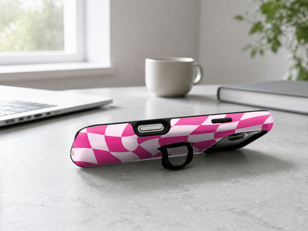 Hot Pink Wavy Checkerboard MagSafe Loop iPhone Case shown in a neutral white professional lifestyle setting