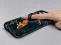 Japanese Koi Fish MagSafe Loop iPhone Case shown in use with a finger through the horizontal loop