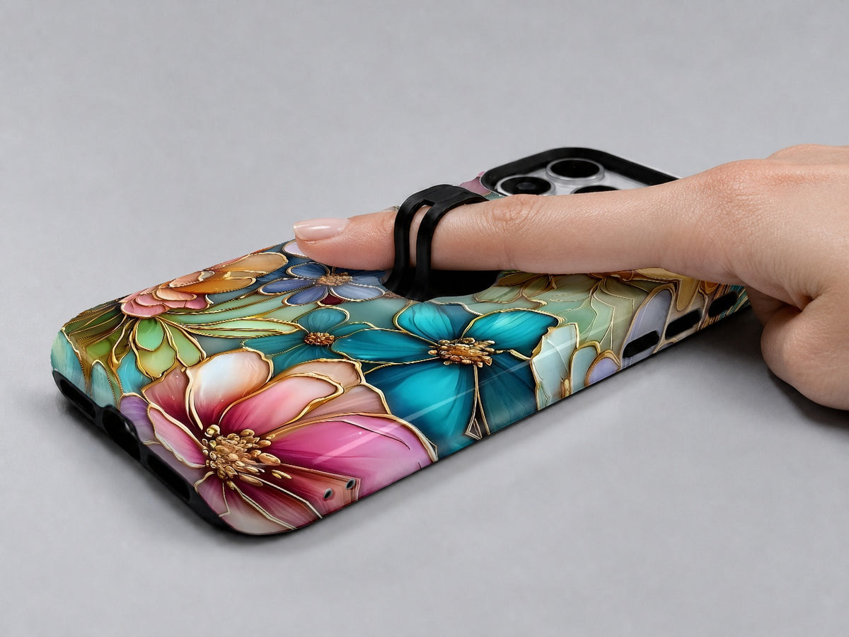 Jewel Tone Stained Glass Floral MagSafe Loop iPhone Case shown in use with a finger through the horizontal loop