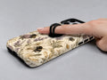 Lavender Bumblebee Botanical MagSafe Loop iPhone Case shown in use with a finger through the horizontal loop