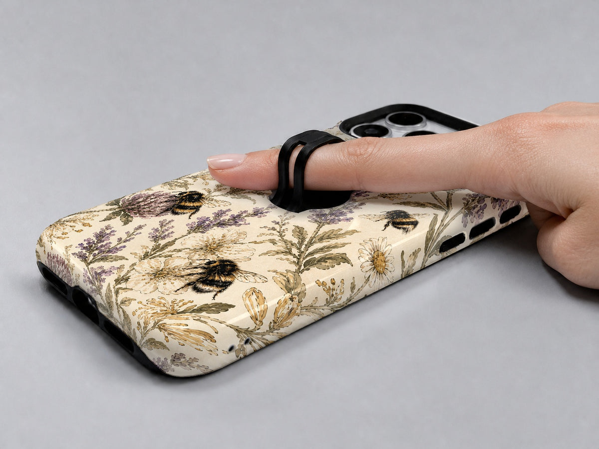 Lavender Bumblebee Botanical MagSafe Loop iPhone Case shown in use with a finger through the horizontal loop
