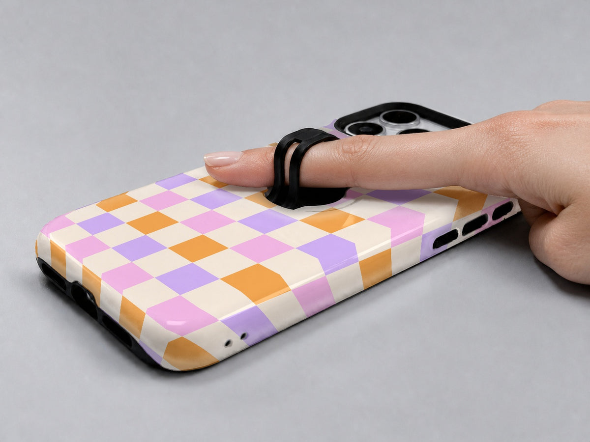 Lavender Peach Checkerboard MagSafe Loop iPhone Case shown in use with a finger through the horizontal loop