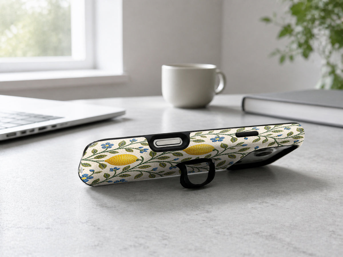 Lemon Botanical MagSafe Loop iPhone Case shown in a neutral white professional lifestyle setting