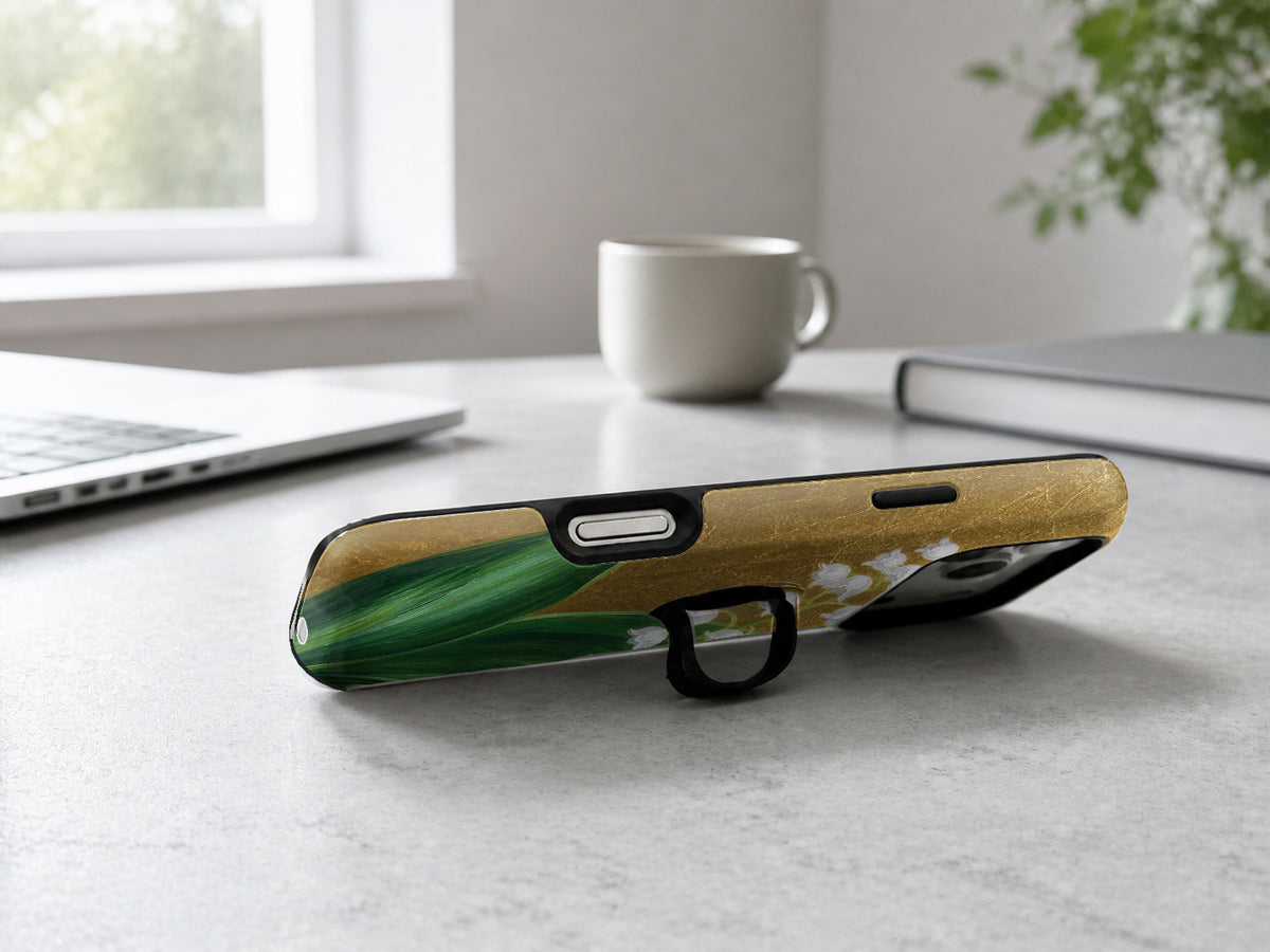 Lily of the Valley on Gold MagSafe Loop iPhone Case shown in a neutral white professional lifestyle setting