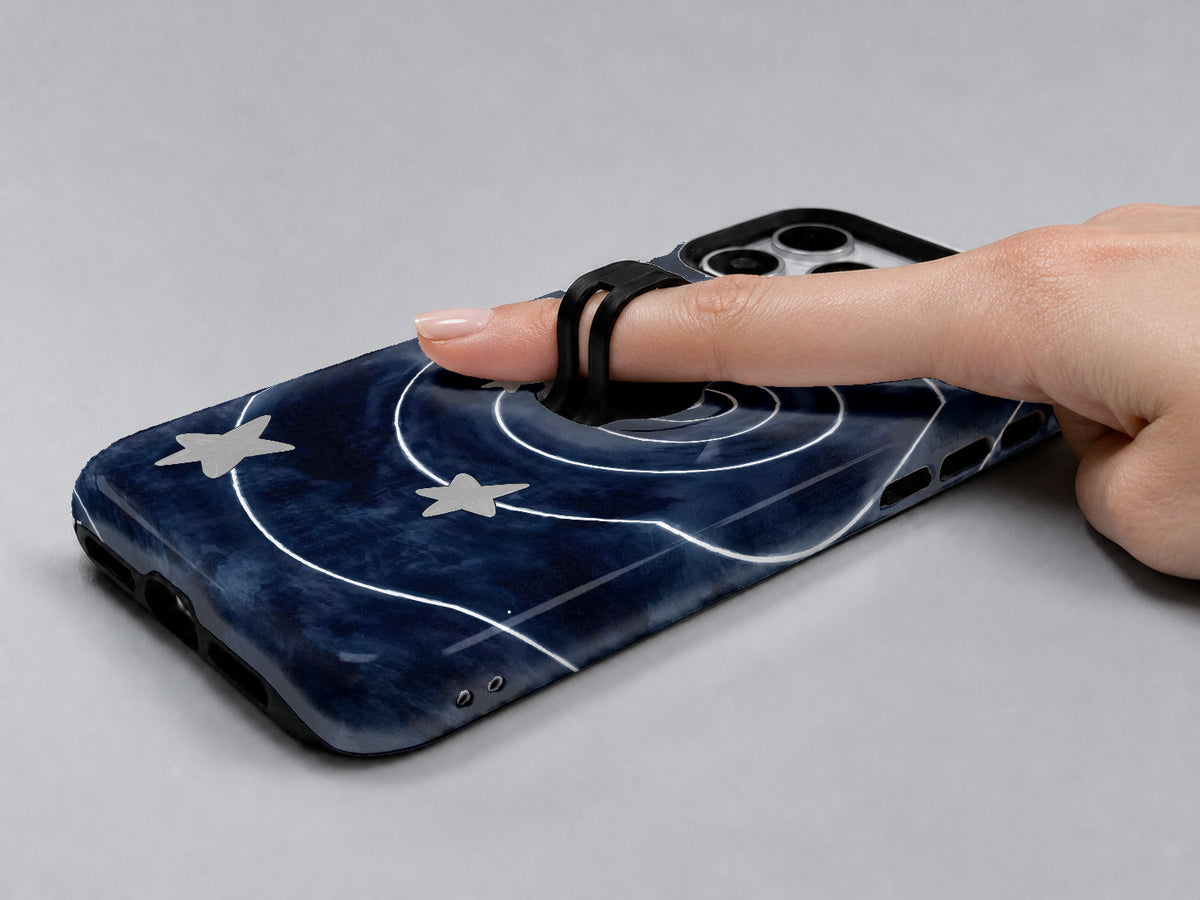 Midnight Blue Celestial Spiral MagSafe Loop Case, shown with a finger through the loop