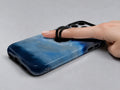 Midnight Navy Sky Blue Color Block MagSafe Loop iPhone Case shown in use with a finger through the horizontal loop