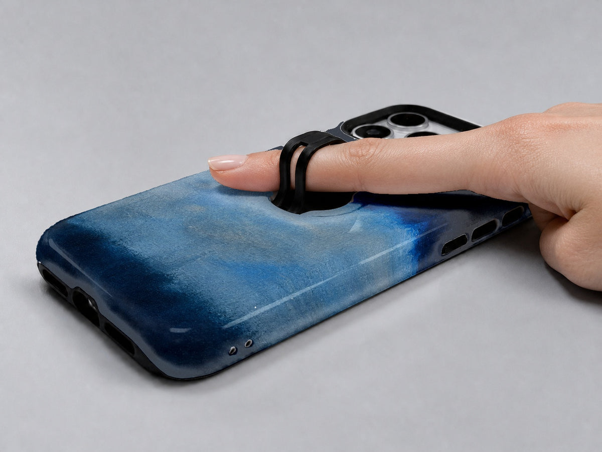 Midnight Navy Sky Blue Color Block MagSafe Loop iPhone Case shown in use with a finger through the horizontal loop