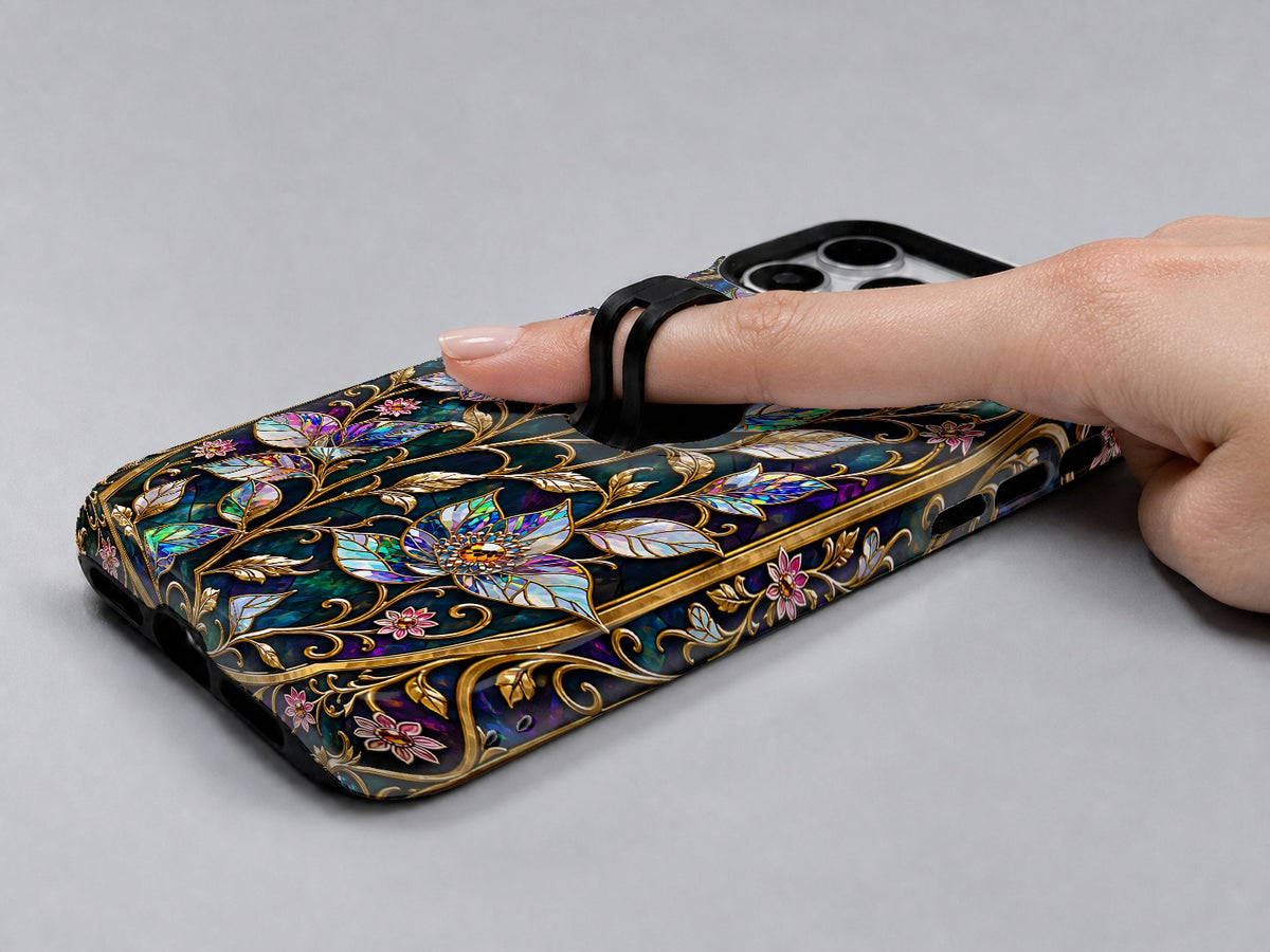 Midnight Ornate Jewel Floral MagSafe Loop iPhone Case shown in use with a finger through the horizontal loop