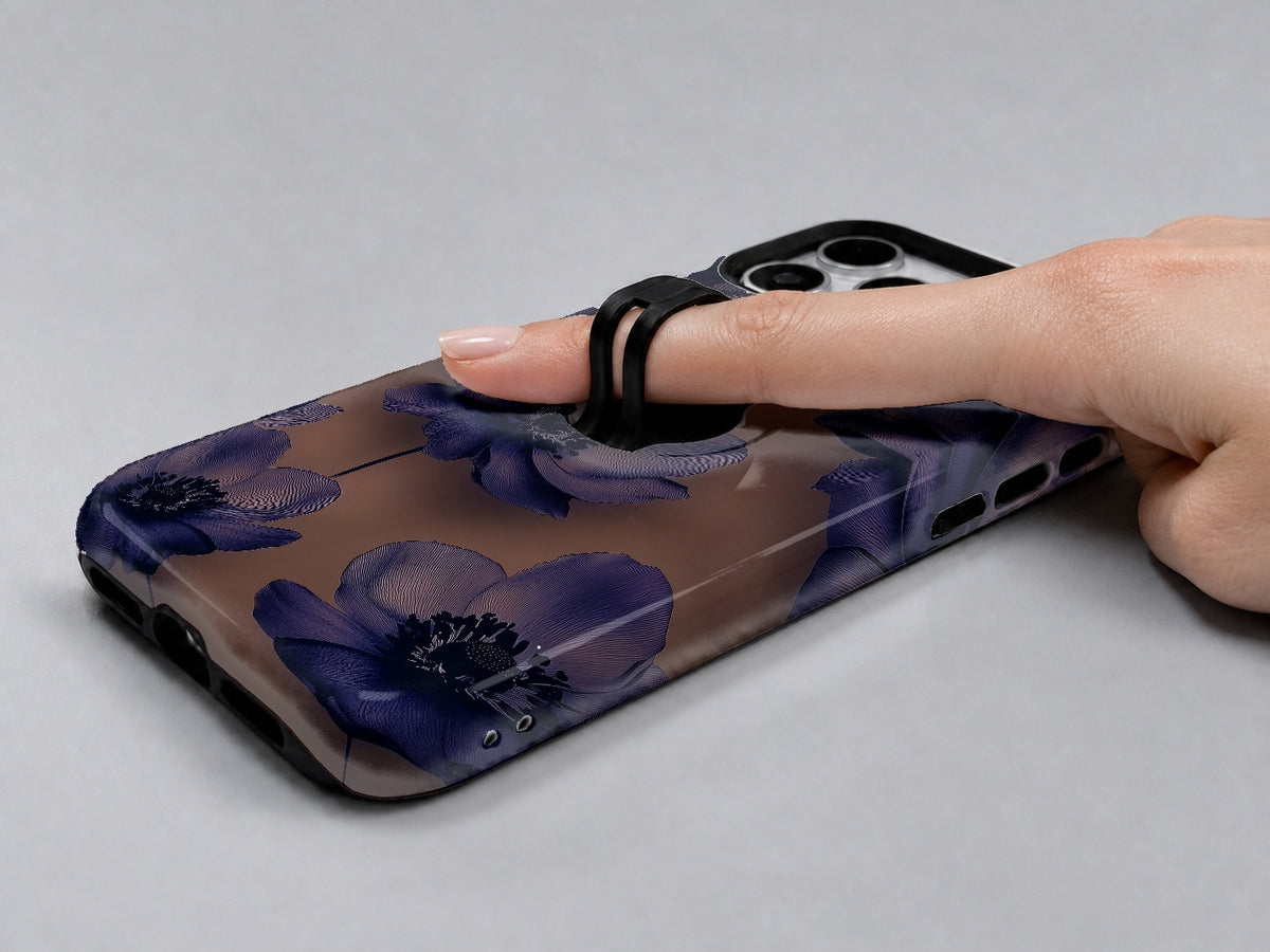 Midnight Purple Floral MagSafe Loop iPhone Case shown in use with a finger through the horizontal loop