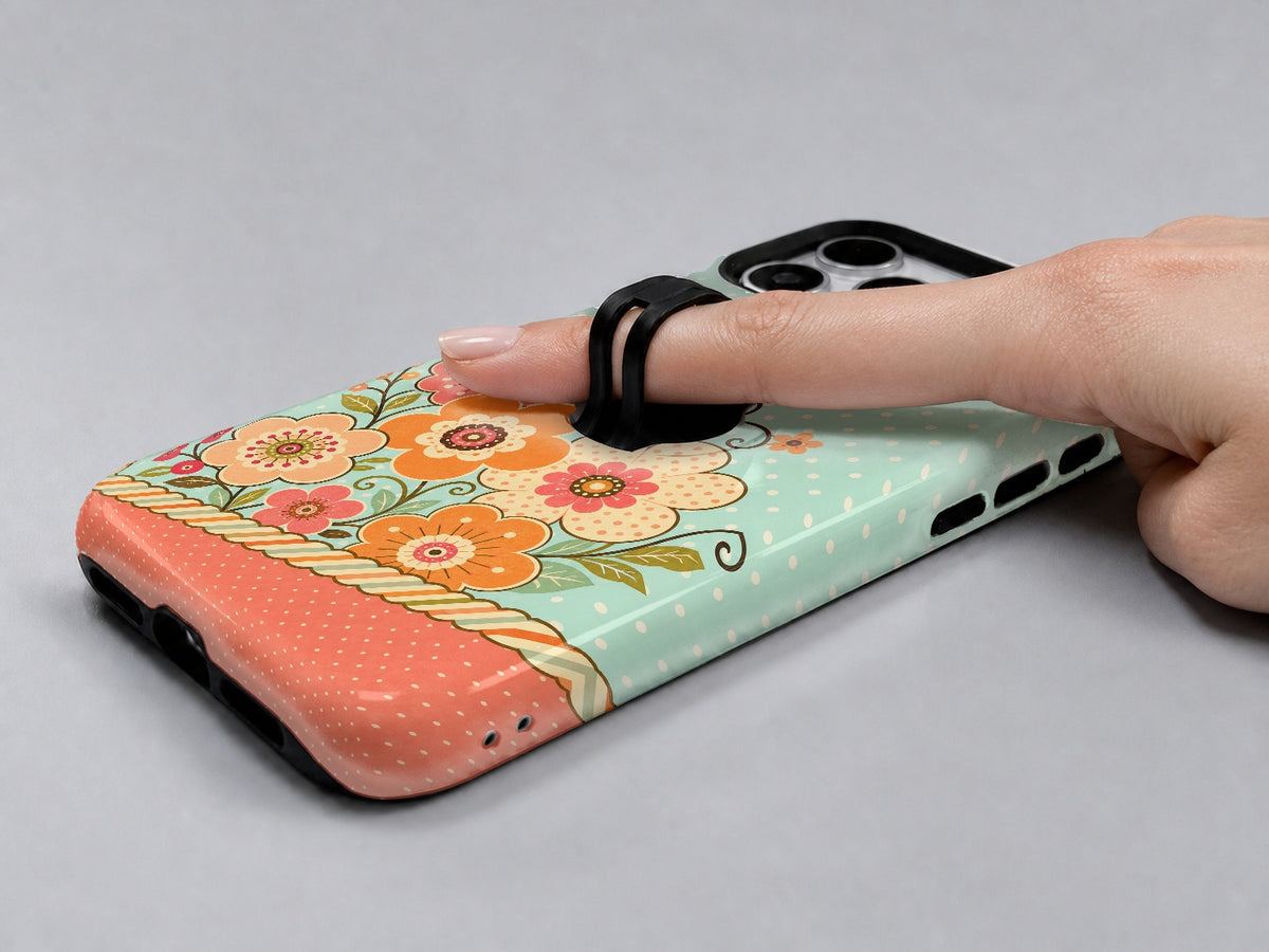 Mint Retro Folk Floral MagSafe Loop iPhone Case shown in use with a finger through the horizontal loop