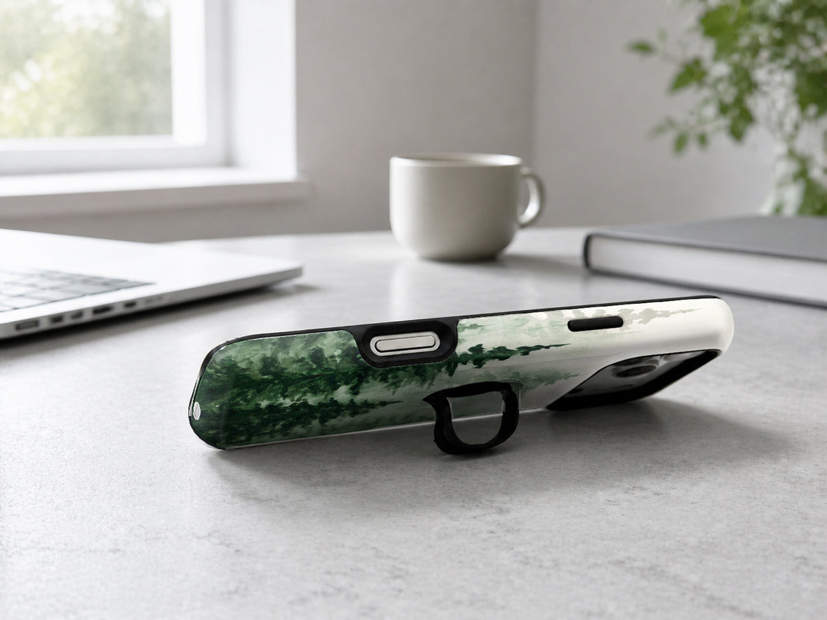 Misty Evergreen Forest MagSafe Loop iPhone Case shown in a neutral white professional lifestyle setting