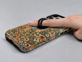 Moroccan Mosaic Tile MagSafe Loop iPhone Case shown in use with a finger through the horizontal loop
