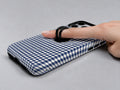 Navy Blue and White Gingham MagSafe Loop Case, shown with a finger through the loop